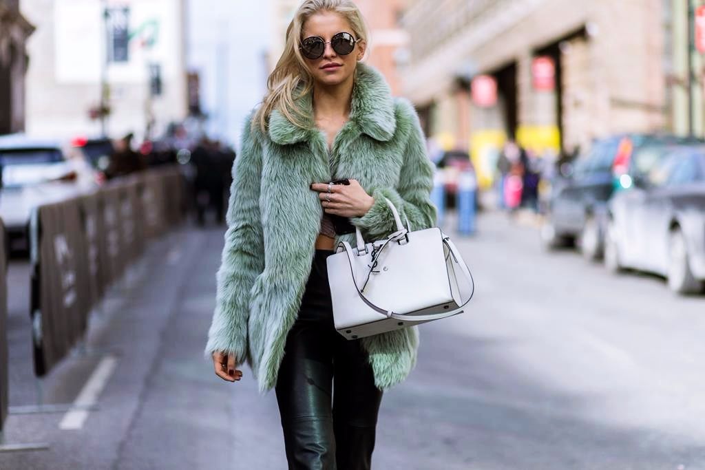 German fashion blogger Caroline Daur wearing a green Topshop Unique fluffy fur jacket, black Zara.